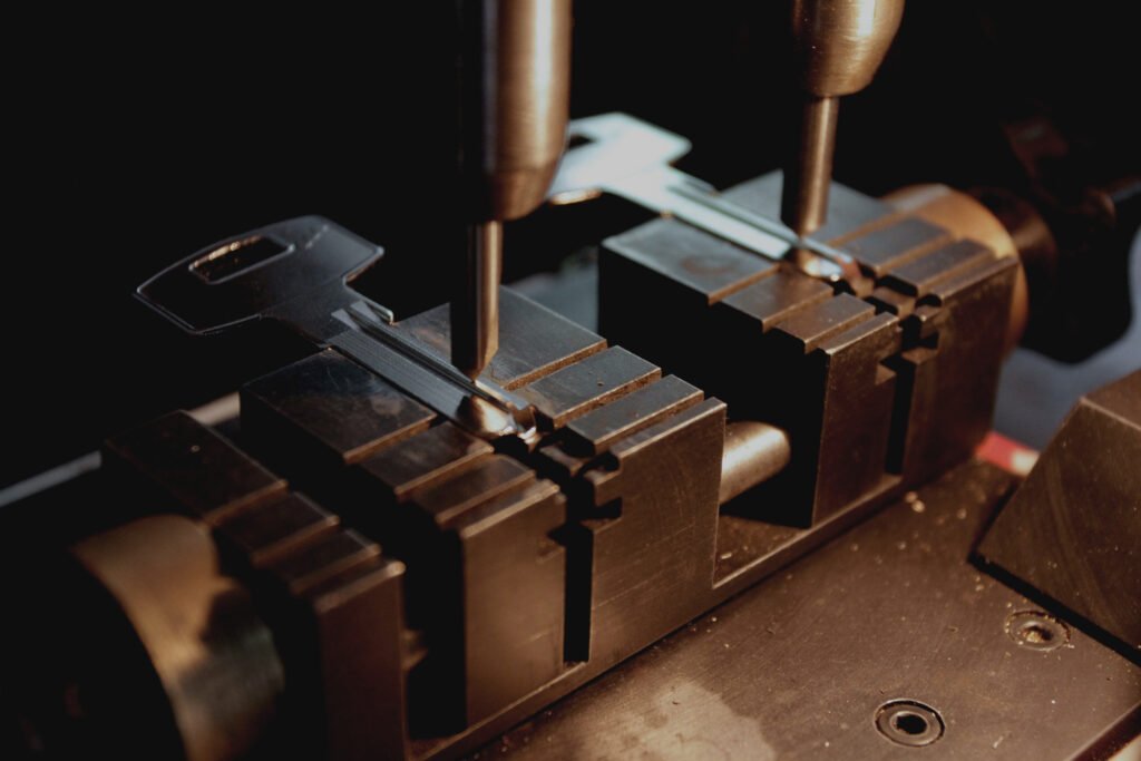 CNC Key Milling machine preparing to cut a car key.